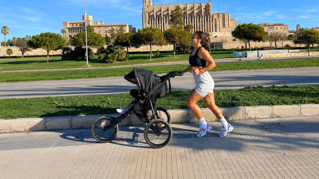 Parent running with a baby in the Out ’n’ About Nipper Sport V5 jogging stroller on a sunny urban city path