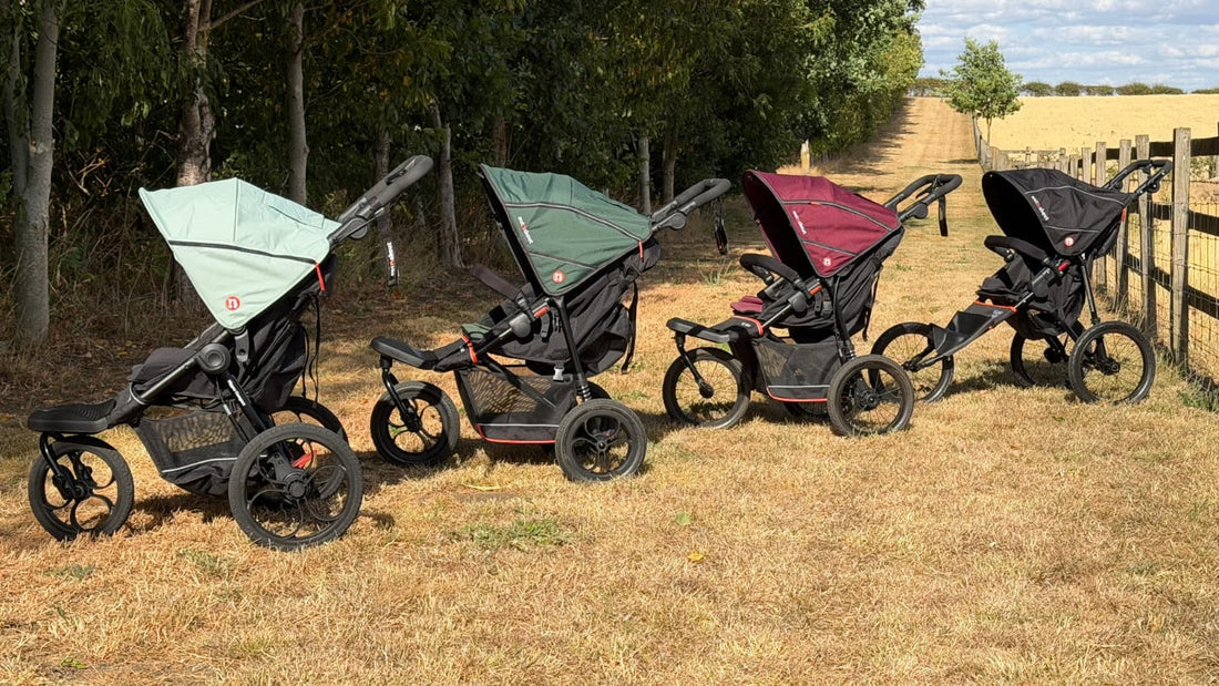 Four Out 'n' About single Nipper buggies, Compact, V6, V6 Plus and Sport, lined up in the countryside for our buggy comparison post